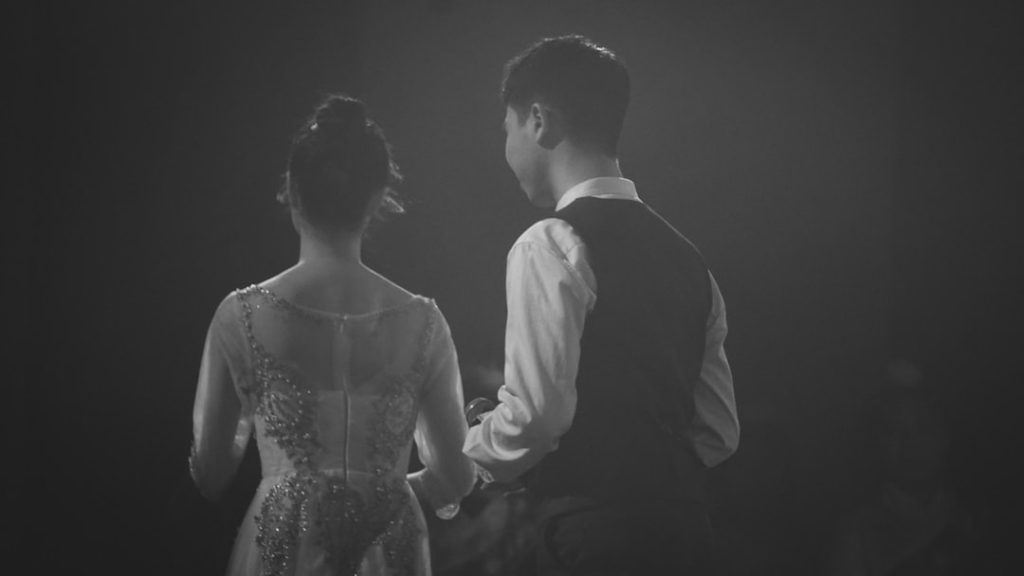a-man-and-a-woman-standing-next-to-each-other-m-qm14tsgni