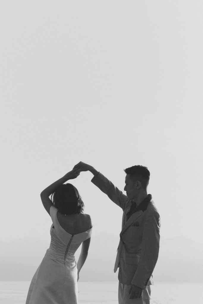 a-man-and-woman-holding-hands-buynte1k6km